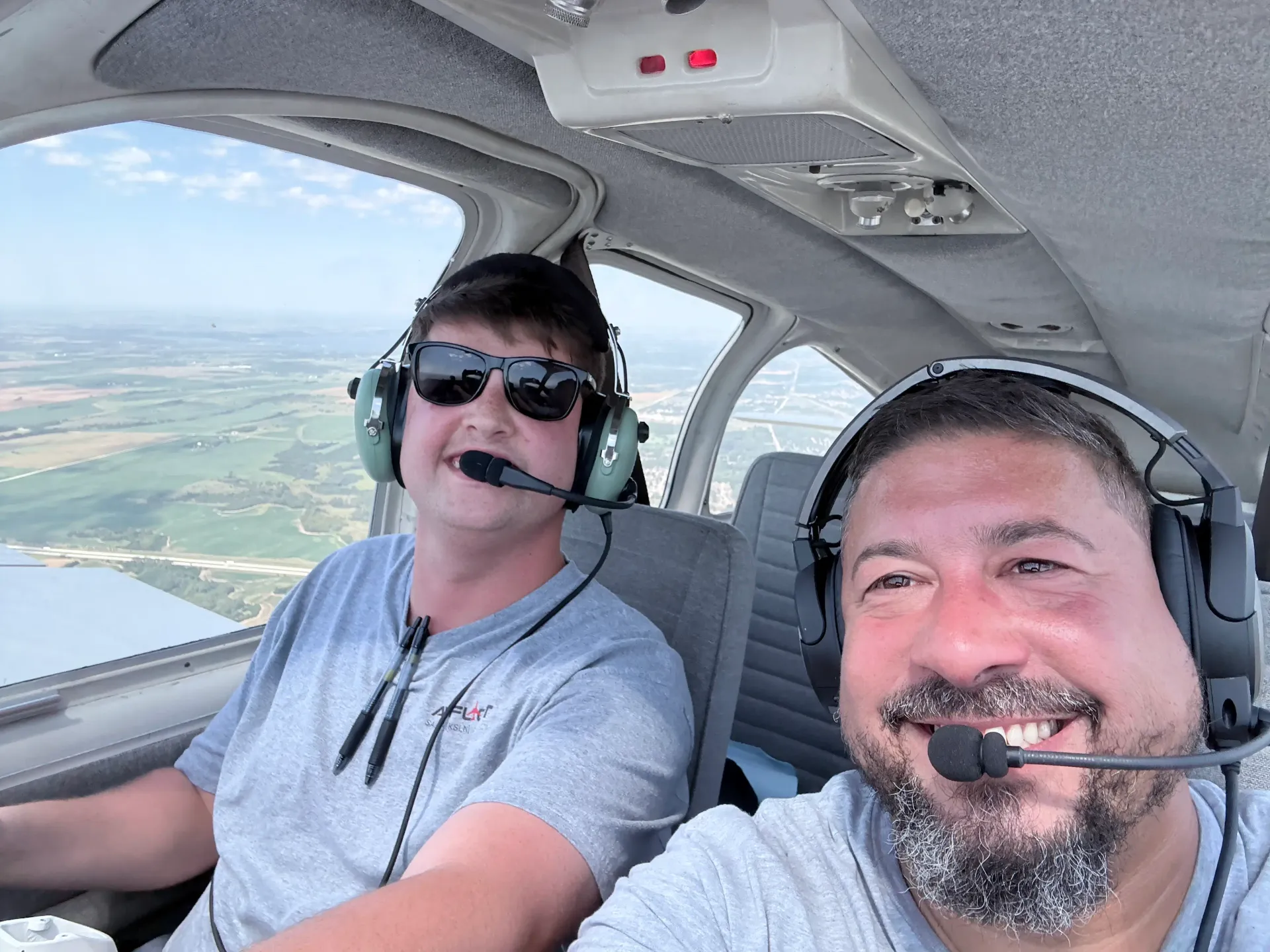 Flight instructor and student wearing headsets during a cockpit training flight